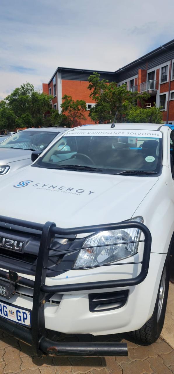 Synergy Isuzu service bakkie, front view at a sectional title complex